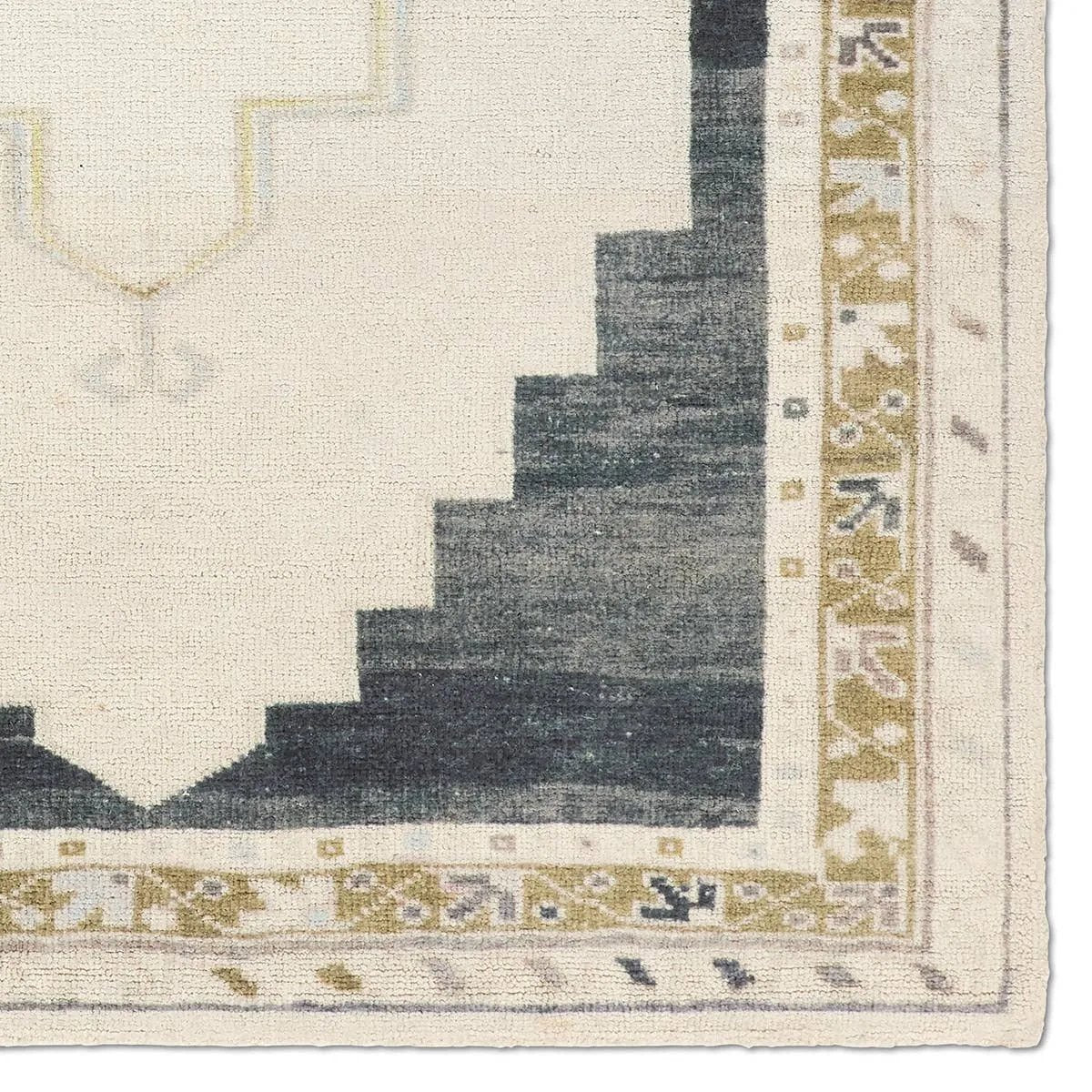 Featuring Stellar Rug by Jaipur Living at Amethyst Home. The Stellar design merges timeless tradition with a vintage-inspired aesthetic. Featuring a striking central medallion, this rug is set against an elegant beige and black backdrop, accented by rich green detailing. Its classic pattern, paired with a gently distressed finish, creates an heirloom quali. Amethyst Home provides interior design, new home construction design consulting, vintage area rugs, and lighting in the Washington metro area.