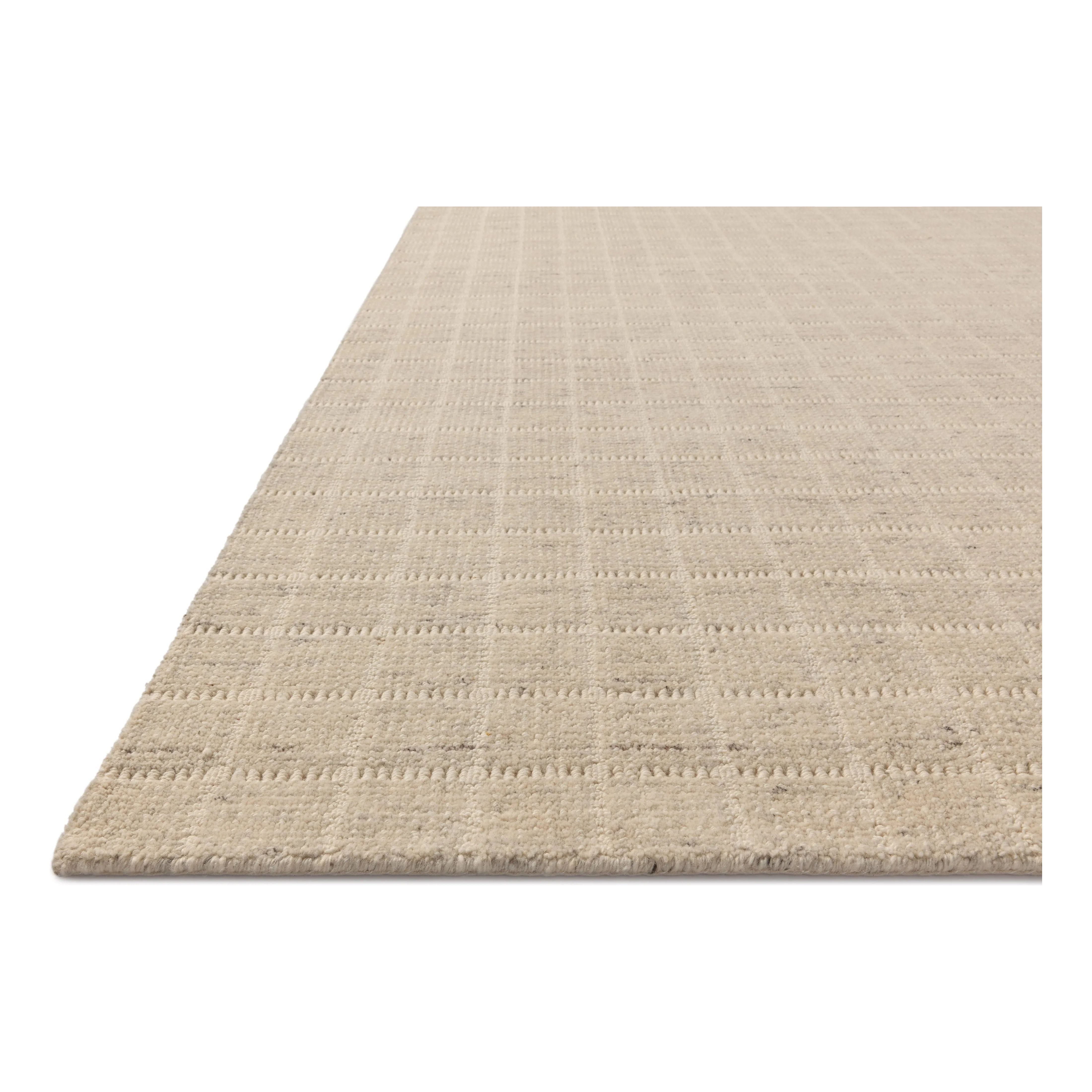 The Cedar Collection by Amber Lewis x Loloi is a hand-loomed area rug with a clean gridded design in contrasting ivory. The rugs blended wool and cotton pile is substantial and soft, with flecked tones that add depth to the neutral palette. Amethyst Home provides interior design, new home construction design consulting, vintage area rugs, and lighting in the Alpharetta metro area.