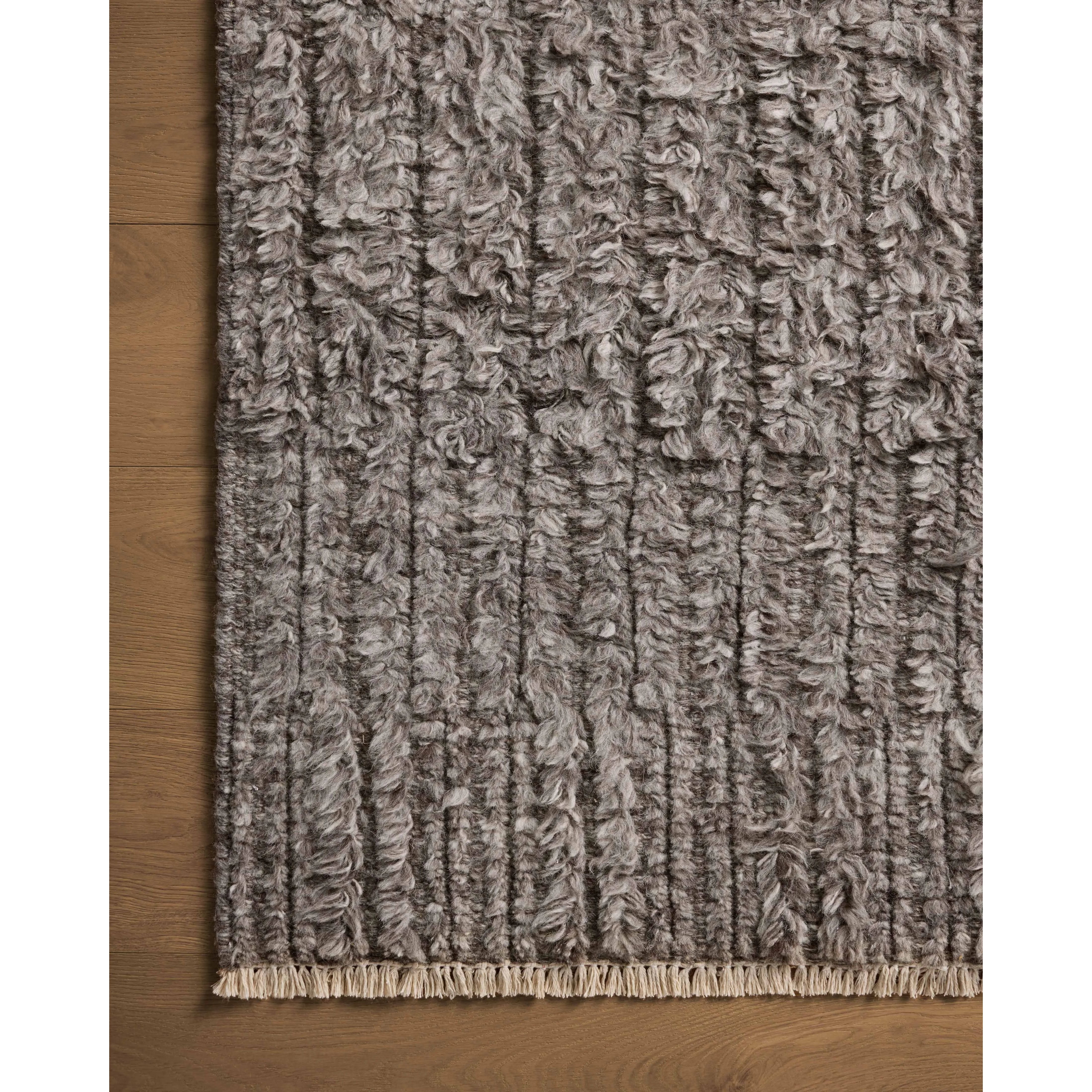 Irresistible to walk upon, the Dana Granite Rug by Brigette Romanek x Loloi has a high-low texture that alternates between a subtly shaggy pile and a soft base. Horizontal broken stripes give the area rug a fresh and energized structure, while a finish of fringe along the edges accentuates its sense of movement. Amethyst Home provides interior design, new home construction design consulting, vintage area rugs, and lighting in the Winter Garden metro area.