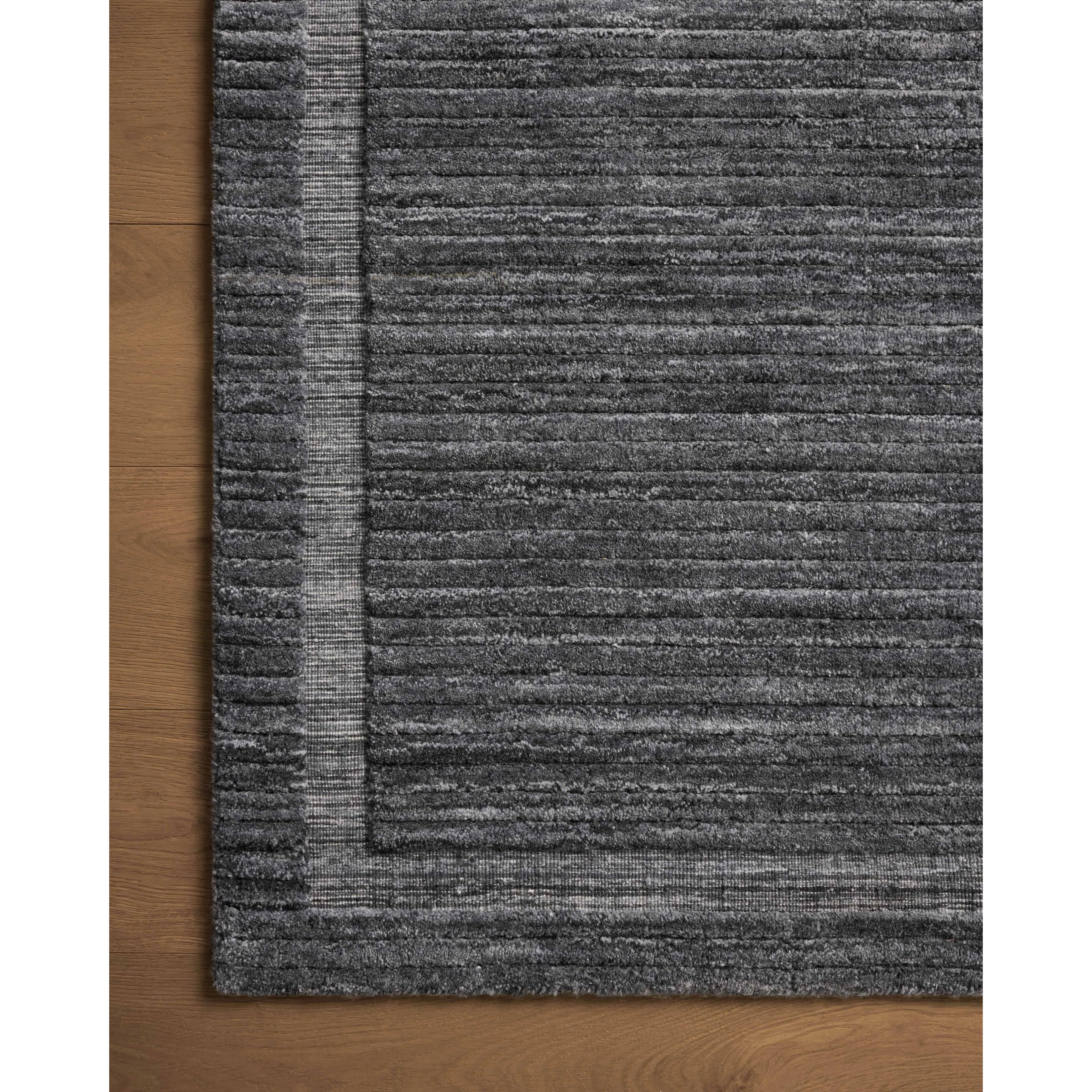 Irresistible to walk upon, the Dana Ink Rug by Brigette Romanek x Loloi has a high-low texture that alternates between a subtly shaggy pile and a soft base. Horizontal broken stripes give the area rug a fresh and energized structure, while a finish of fringe along the edges accentuates its sense of movement. Amethyst Home provides interior design, new home construction design consulting, vintage area rugs, and lighting in the Des Moines metro area.