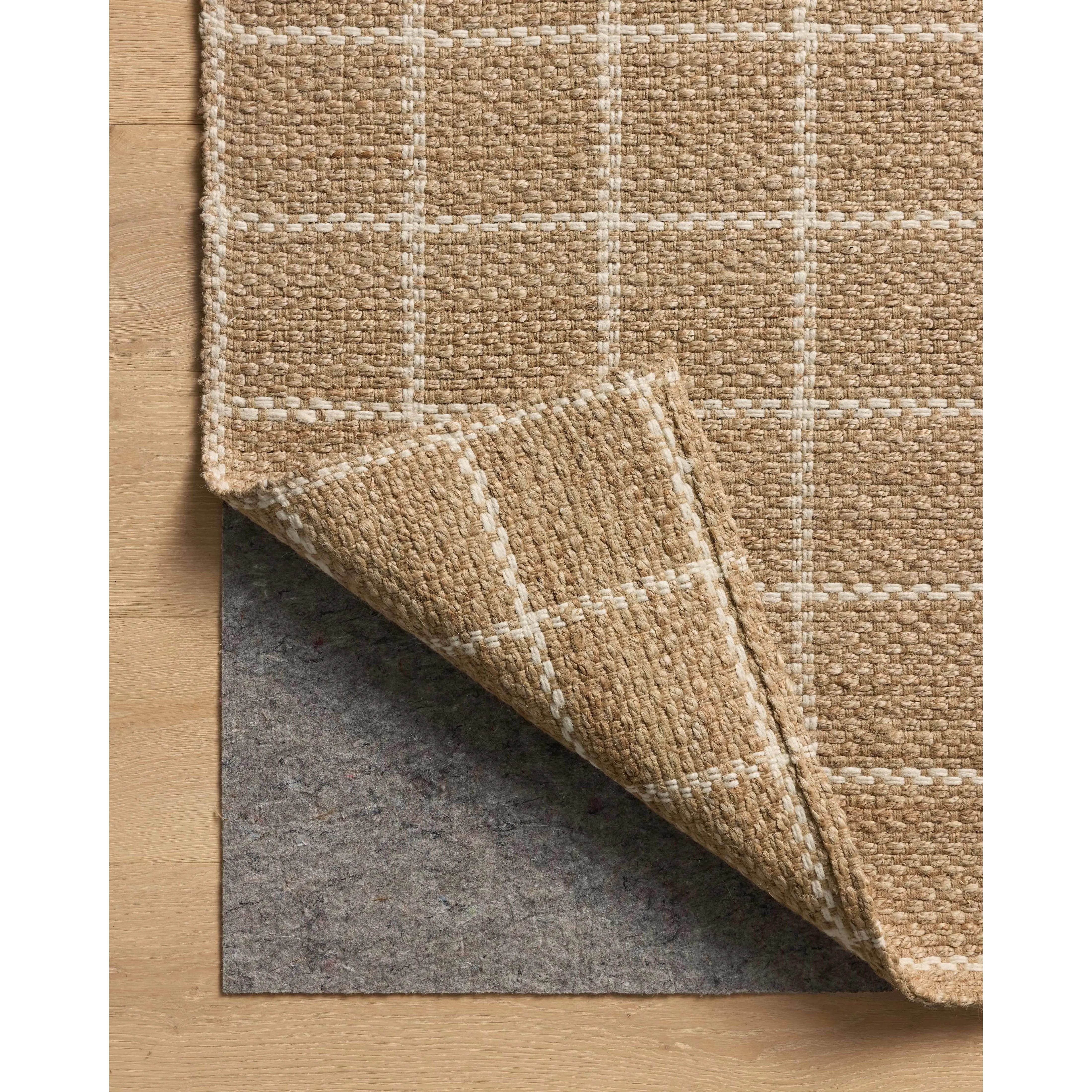 The Fletcher Collection from Chris Loves Julia x Loloi is a power-loomed jute rug with a large-scale grid pattern for an organic modern twist on a classic style. The rugs chunky texture and checkerboard-detailed lines are the refined details that Chris Loves Julia is known for, while the rugs natural palette allows for easy styling in any room. Amethyst Home provides interior design, new home construction design consulting, vintage area rugs, and lighting in the Charlotte metro area.