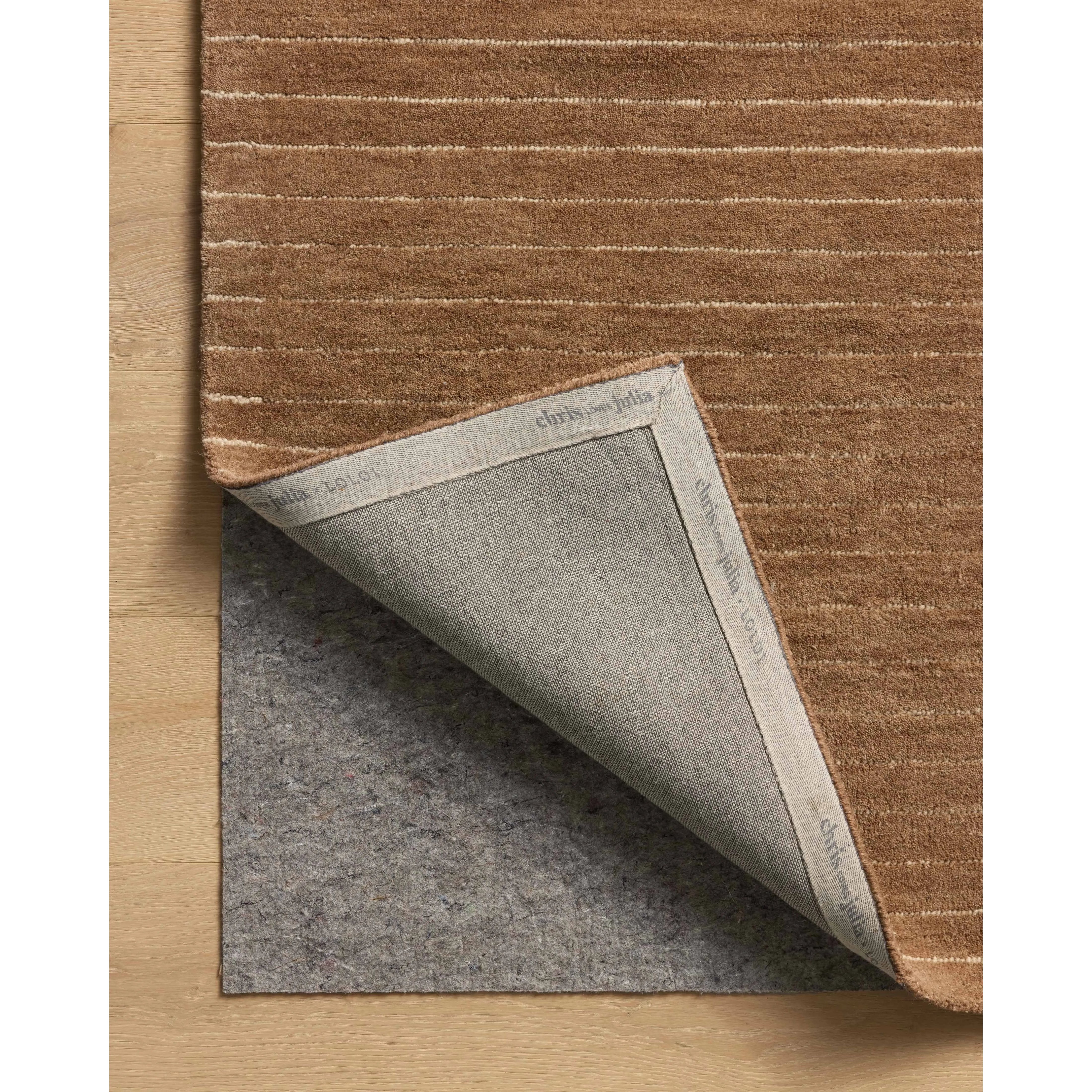The Henry Collection from Chris Loves Julia x Loloi is a hand-tufted area rug that adds a touch of personality to a solid-colored design that can easily pair with other patterns in the room. These designs feature tufted stripes for subtle contrast and depth. The rugs wool pile is thick and satisfying to walk on, with gently nuanced color variation. Amethyst Home provides interior design, new home construction design consulting, vintage area rugs, and lighting in the Nashville metro area.