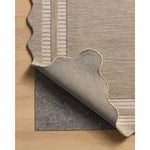 The Scottie Collection from Chris Loves Julia x Loloi is a hand-tufted wool area rug with a playful scalloped edge and lower-pile, striped border for a touch of structure. The rugs overall pile is thick and plush, available in easygoing earth tones and neutral colorways. Amethyst Home provides interior design, new home construction design consulting, vintage area rugs, and lighting in the Austin metro area.