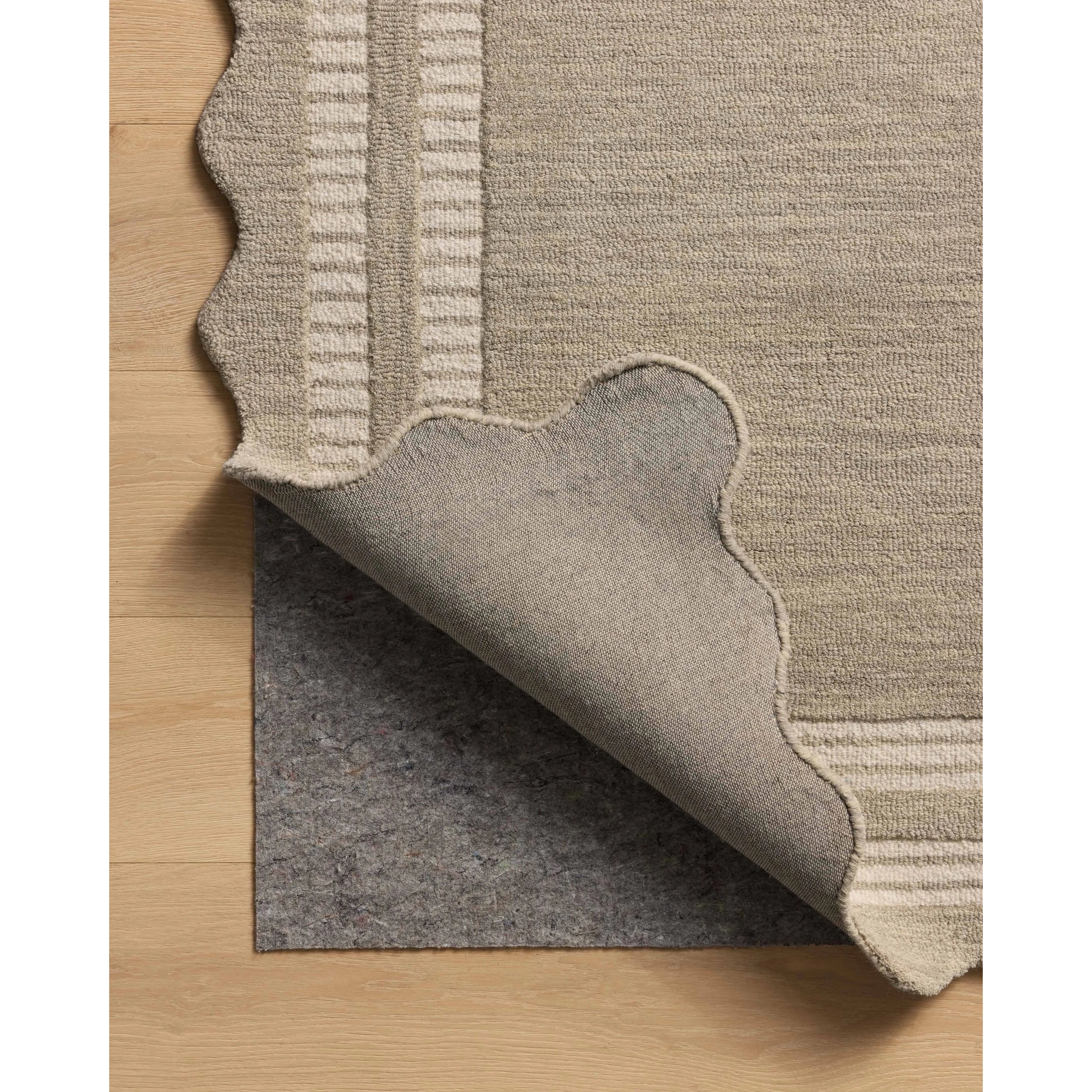 The Scottie Collection from Chris Loves Julia x Loloi is a hand-tufted wool area rug with a playful scalloped edge and lower-pile, striped border for a touch of structure. The rugs overall pile is thick and plush, available in easygoing earth tones and neutral colorways. Amethyst Home provides interior design, new home construction design consulting, vintage area rugs, and lighting in the Austin metro area.