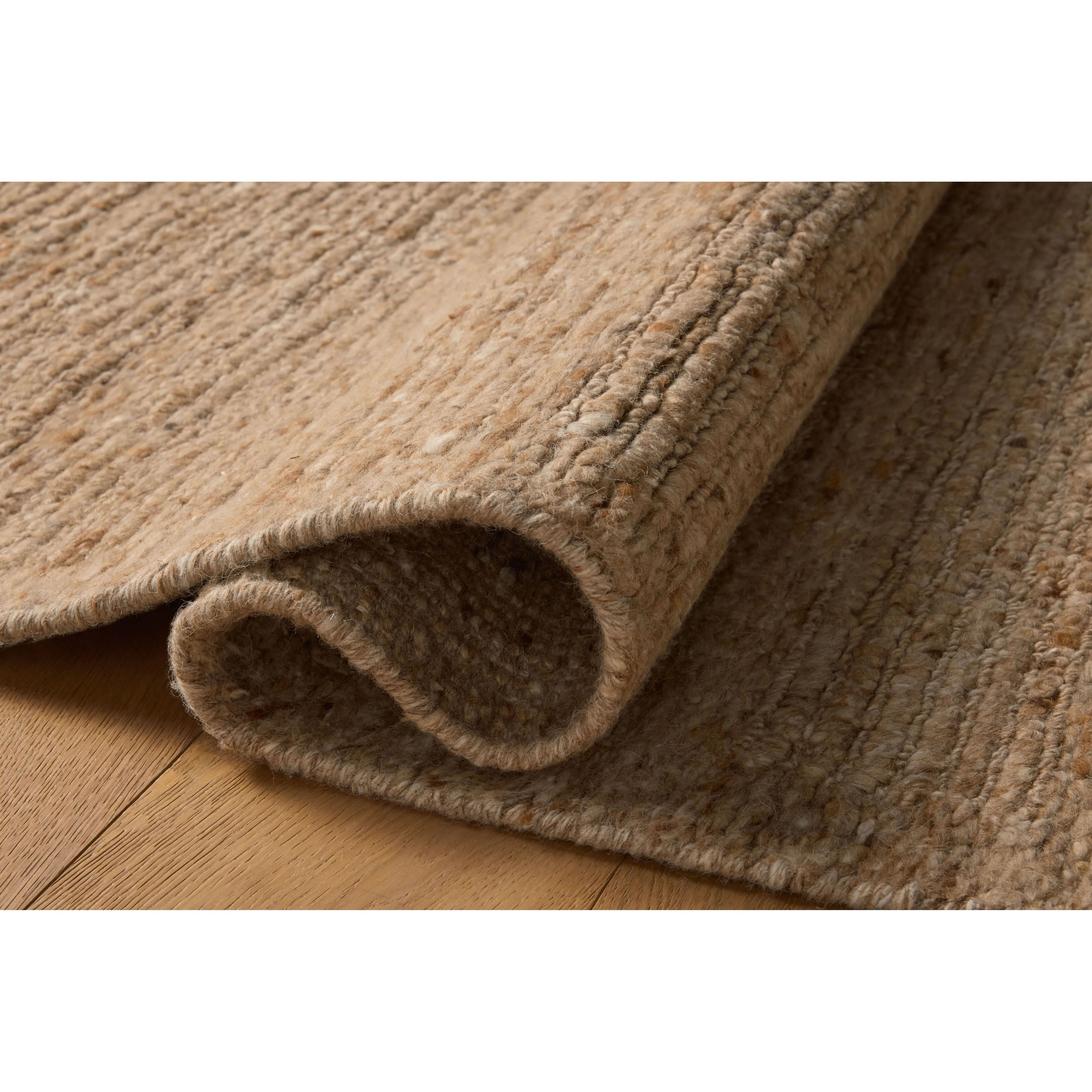 The Lennox Collection by Leanne Ford x Loloi is a statement area rug made with natural undyed wool that reveals subtle color differentiation in creamy neutral tones. The rug is hand-woven with a labor-intensive soumak weave, alternating rows of thick and thin looped yarns for an organic, inviting texture. Amethyst Home provides interior design, new home construction design consulting, vintage area rugs, and lighting in the Nashville metro area.