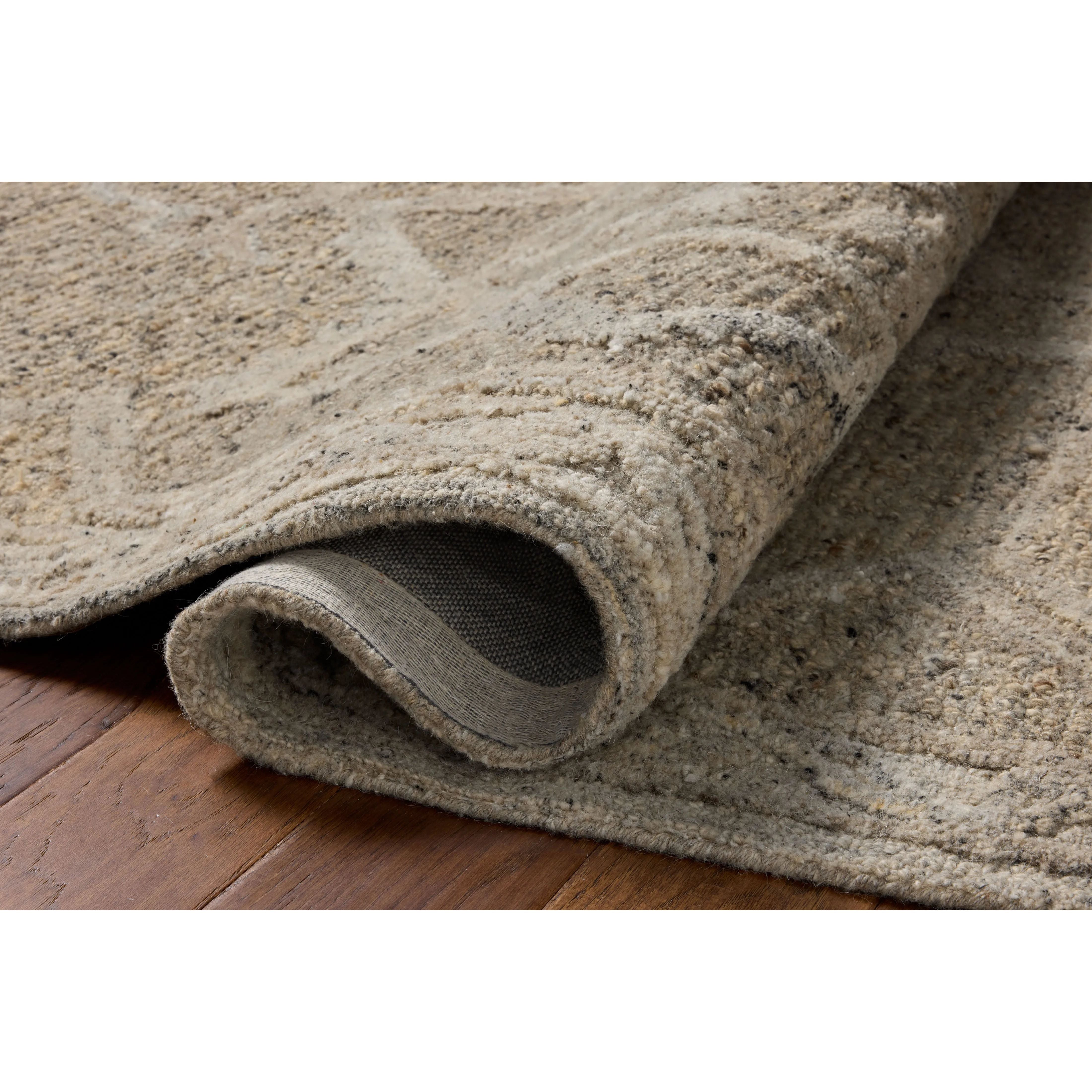 The Mabel Collection is a chunky wool area rug with a modernized take on traditional Turkish design. The rugs pattern rises with a higher pile for added dimension, while the neutral stone palette makes it easy to style in living rooms, bedrooms, and more. Amethyst Home provides interior design, new home construction design consulting, vintage area rugs, and lighting in the Austin metro area.