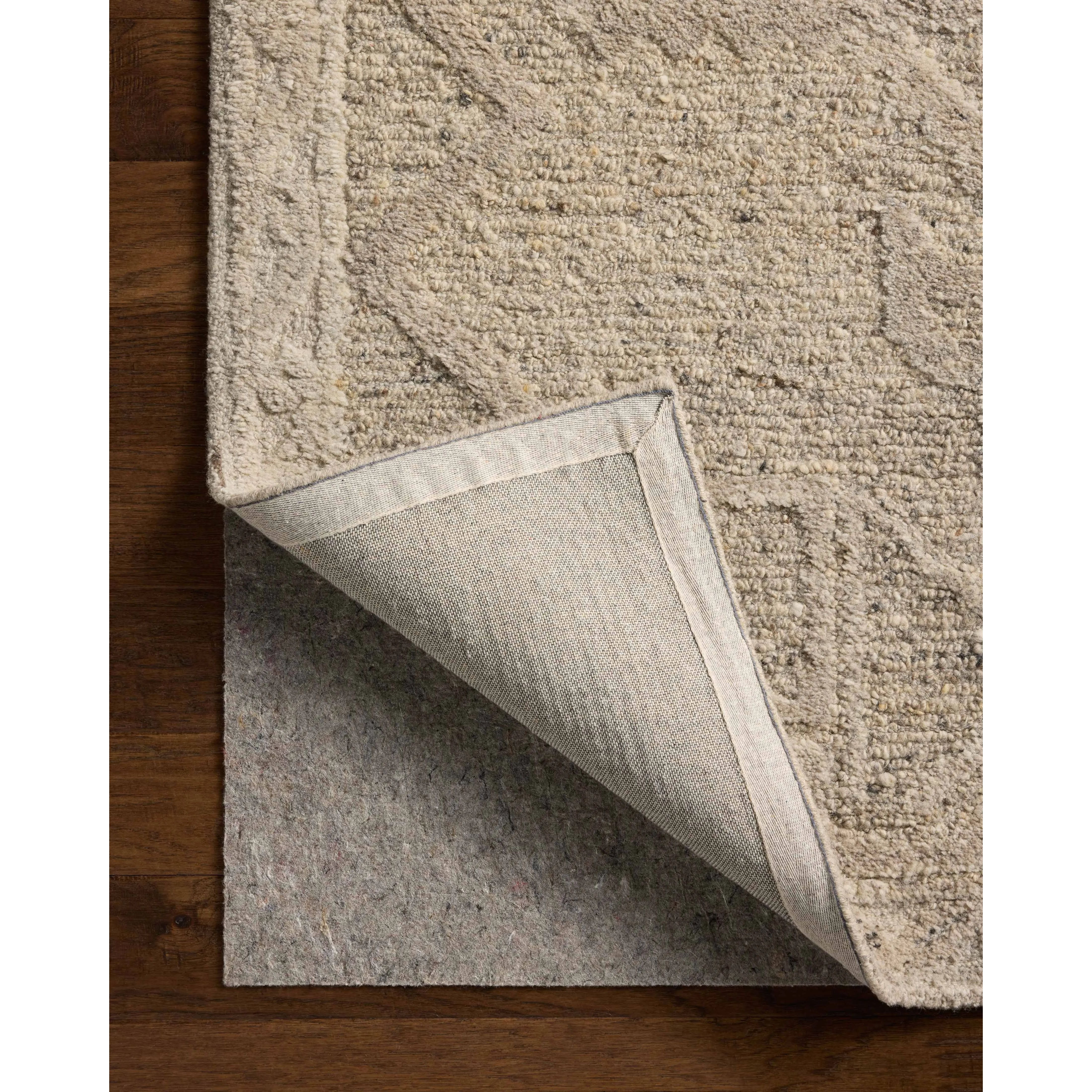 The Mabel Collection is a chunky wool area rug with a modernized take on traditional Turkish design. The rugs pattern rises with a higher pile for added dimension, while the neutral stone palette makes it easy to style in living rooms, bedrooms, and more. Amethyst Home provides interior design, new home construction design consulting, vintage area rugs, and lighting in the Des Moines metro area.