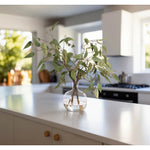 Embrace nature's charm with the green Eucalyptus, thoughtfully displayed in a glass jug. At 23", this piece captures the natural beauty of each petal, making it ideal for brightening up office desks or kitchen countertops. This piece brings everlasting elegance, staying vibrant for any occasion without the hassle of care Amethyst Home provides interior design, new home construction design consulting, vintage area rugs, and lighting in the Omaha metro area.