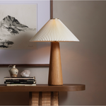 Modern minimal meets traditional. A tapered wood table lamp base is topped with a design-forward pleated shade. Amethyst Home provides interior design, new home construction design consulting, vintage area rugs, and lighting in the Raleigh metro area.