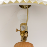 Featuring Nora Light Oak Table Lamp by Four Hands at Amethyst Home. Modern minimal meets traditional. A tapered wood table lamp base is topped with a design-forward pleated shade.Overall Dimensions: 20"W x 20"L x 26"HColors: Light Oak, Taupe Cloth Cord, Antique Brass, Aged Brass, Cream LinenMaterials: Solid Oak, Vacuum Thermoplastic, Steel Plating, Brass, 100%. Amethyst Home provides interior design, new home construction design consulting, vintage area rugs, and lighting in the Malibu metro area.