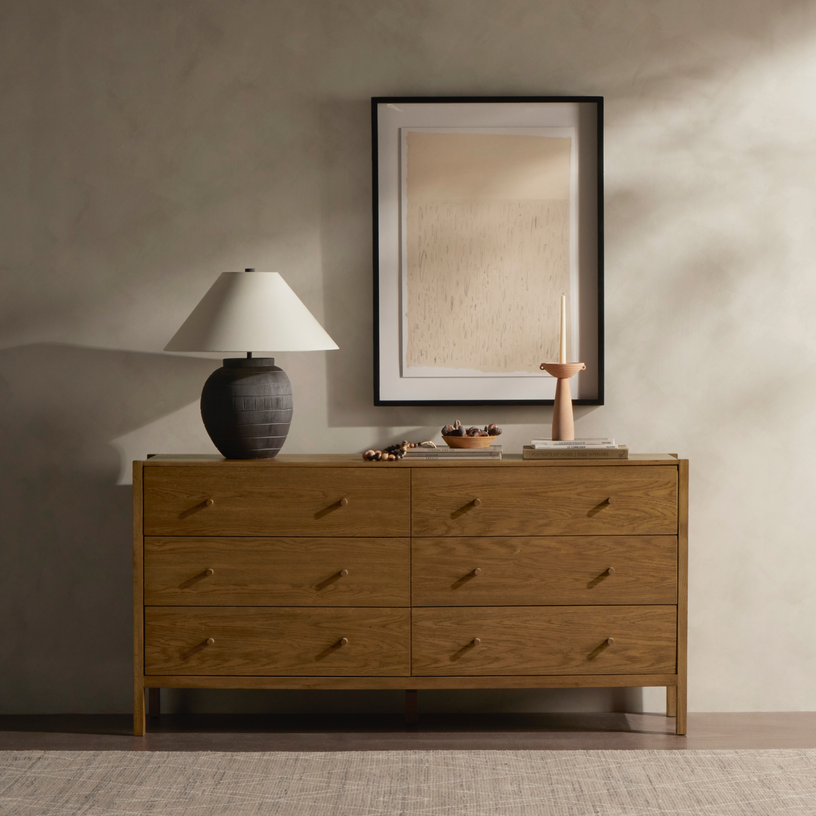 With simple shaping inspired by midcentury casing, exposed framework and a warm oak finish bring a handcrafted, minimalist look to modern bedroom styling, with six spacious drawers for ample storage. Amethyst Home provides interior design, new home construction design consulting, vintage area rugs, and lighting in the Austin metro area.