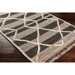 Bring a touch of global-inspired sophistication to your living space with the Cadiz Handmade Rug. This hand knotted wool rug has a plush pile, offering an inviting feel underfoot. The fringe detail adds texture and visual interest, while its Moroccan-style pattern gives this piece a timeless yet modern look. Amethyst Home provides interior design, new home construction design consulting, vintage area rugs, and lighting in the Des Moines metro area.