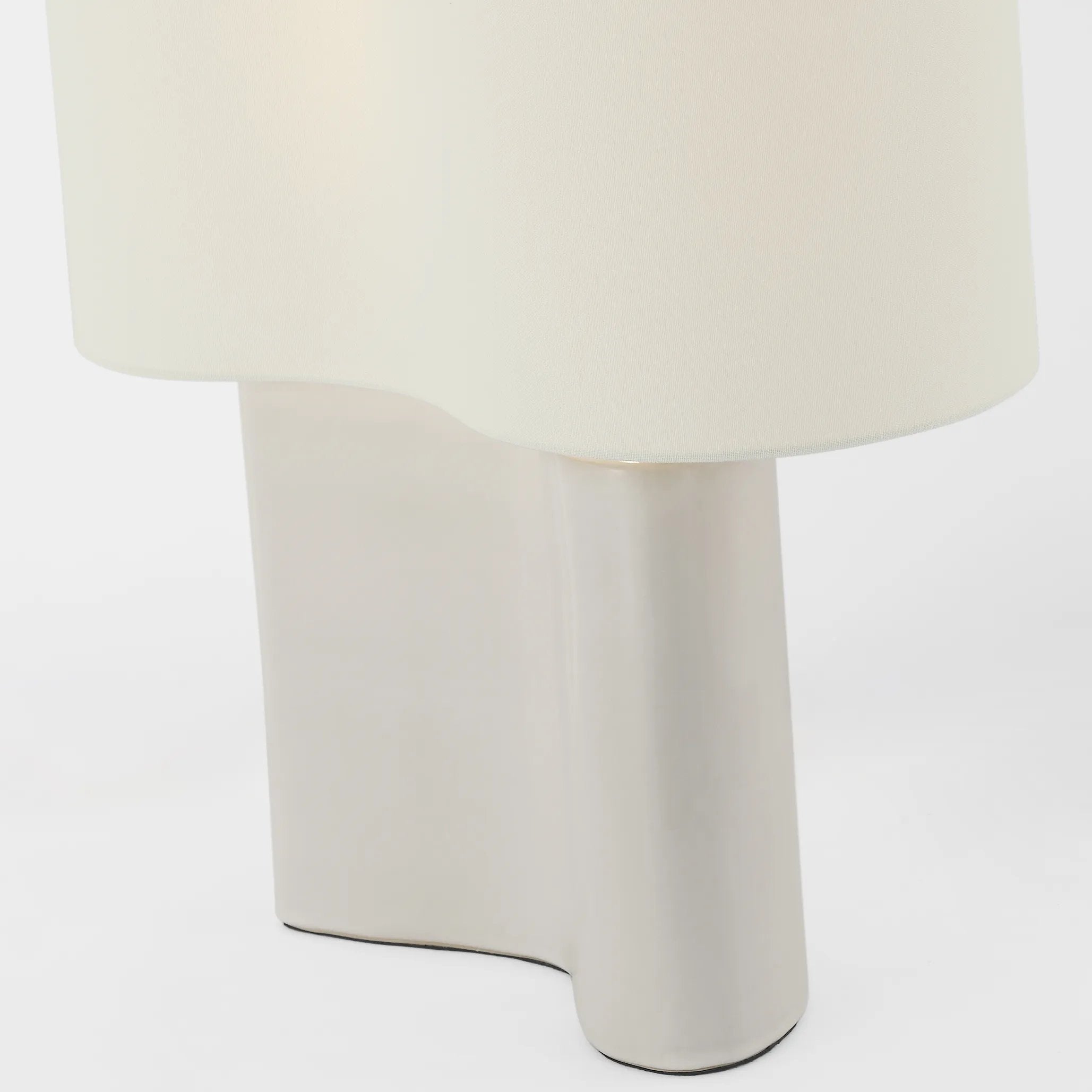 Embrace the ethereal glow of the Mishca Medium Table Lamp. Its smooth, organic shape adds a touch of elegance to any space. With a glossy finish that adds depth and texture, this lamp is a must-have for those who appreciate the finer things in life. Amethyst Home provides interior design, new home construction design consulting, vintage area rugs, and lighting in the Kansas City metro area.