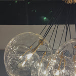Clear glass bulbs dangle for a statement-making centerpiece. Each globe is individually blown, shaped and sculpted by hand through a one-hour process. Brass and glass are 98% recyclable. Designed and sustainably crafted in Poland by Schwung. Amethyst Home provides interior design, new home construction design consulting, vintage area rugs, and lighting in the Dallas metro area.
