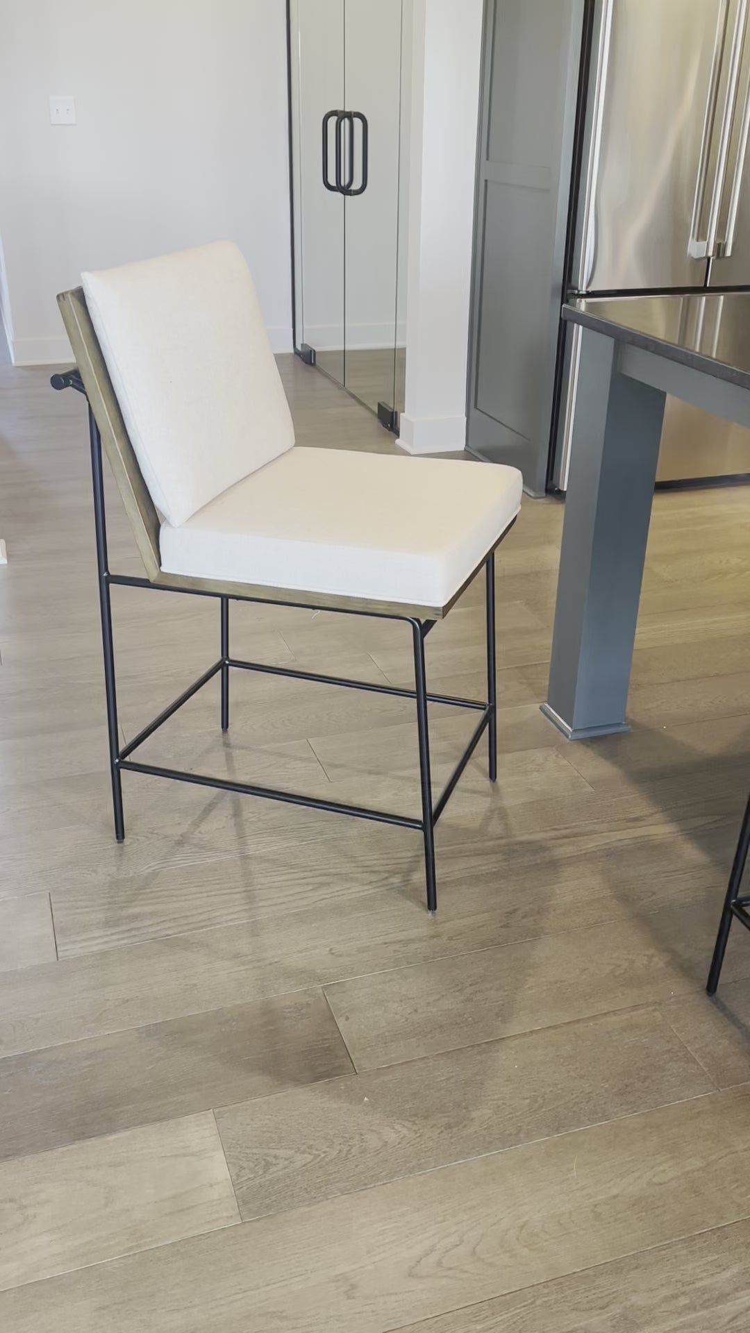 Load video: Fall in love with the back detailing of the Ross -- and stay for the comfort.  Beautiful iron base and wood details make this an unforgettable stool.Materials: Solid Oak, Iron, 92% Pl, 8% Li Amethyst Home provides interior design, new home construction design consulting, vintage area rugs, and lighting in the Newport Beach metro area.
