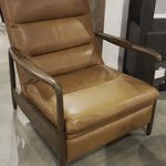 A sleek seat with hidden push-back reclining functionality. This midcentury-inspired recliner features wide chunky channeling paired with slim paddle arms and a tapered wood frame. Designed with a high seat and high back for extra comfy support. Upholstered in a timeless tobacco-hued leather made in a family-owned tannery in Thailand. Amethyst Home provides interior design, new home construction design consulting, vintage area rugs, and lighting in the Calabasas metro area.