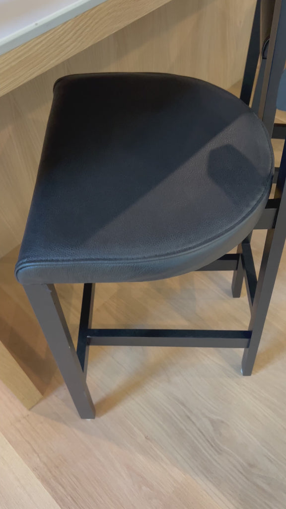 This dark, monochromatic look inspired by Greek design meets black-finished Rosa Morada with black top-grain leather. A slim T-shape frame is perfectly sized for the counter.Overall Dimensions: 20.25"w x 17.75"d x 36.50"hWeight : 11.90 lbsMaterials : Top Grain Leather, Solid Rosa Morada, 100% Polyurethane Foam Amethyst Home provides interior design, new home construction design consulting, vintage area rugs, and lighting in the Kansas City metro area.