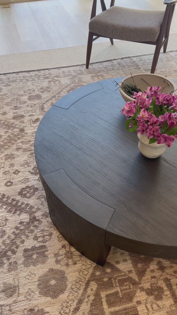 Made from thick, charcoal-finished oak, a rounded coffee table features four legs that pull through to the top, for an intriguing design detail.Overall Dimensions: 48.00"w x 48.00"d x 13.00"hWeight : 94.80 lbsMaterials : Oak Veneer Amethyst Home provides interior design, new home construction design consulting, vintage area rugs, and lighting in the Winter Garden metro area.