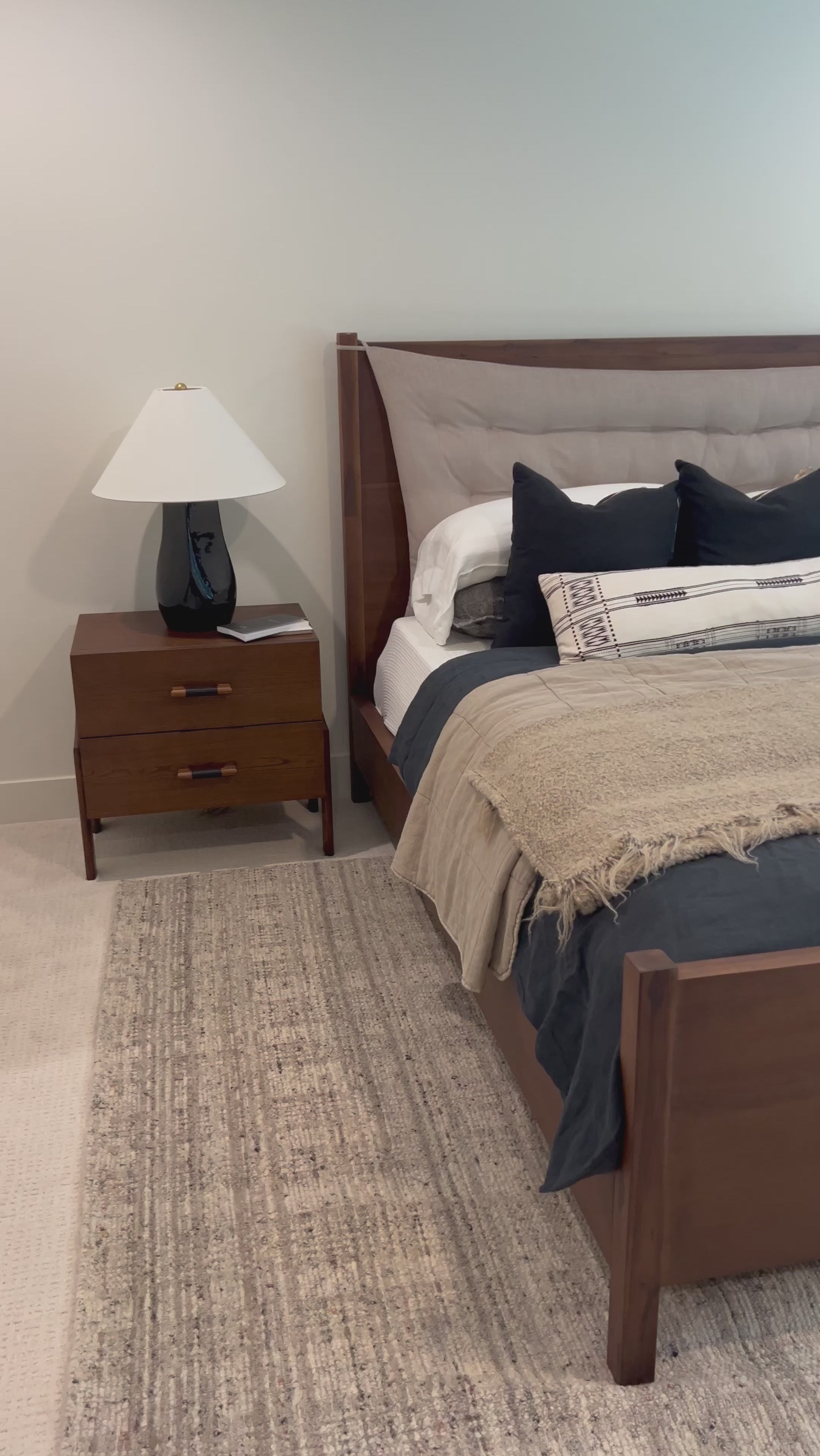 A simple, heavy wood bed frame with a removable sling cushion in a neutral fabric with blind button tufting. Choose the all-wood look or opt for a softer look with the pillow. The cushion is reinforced at the corners for added durability and easily removed for cleaning. Amethyst Home provides interior design, new home construction design consulting, vintage area rugs, and lighting in the Scottsdale metro area.