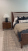 A simple, heavy wood bed frame with a removable sling cushion in a neutral fabric with blind button tufting. Choose the all-wood look or opt for a softer look with the pillow. The cushion is reinforced at the corners for added durability and easily removed for cleaning. Amethyst Home provides interior design, new home construction design consulting, vintage area rugs, and lighting in the Scottsdale metro area.