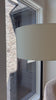 Paired with a slim, black-finished iron post, a tapered ceramic base is finished with a white reactive glaze, making each piece truly unique with subtle variations. An ivory linen shade keeps things looking light and airy. Amethyst Home provides interior design, new home construction design consulting, vintage area rugs, and lighting in the Dallas metro area.