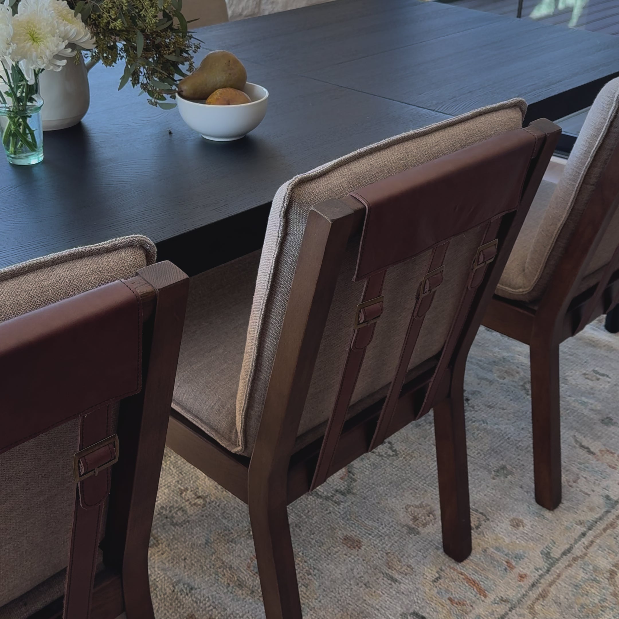 An Amethyst fave -- the Wilmington dining chair has a gorgeous coffee colored textile paired with medium toned wood and interesting leather buckles on the back -- we tied in the gold buckles with the gold chandelier above!  Inspired by the folded pillow form, the seat and back cushions of this parawood dining chair are covered in performance fabric. Amethyst Home provides interior design, new home construction design consulting, vintage area rugs, and lighting in the Austin metro area.