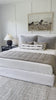 Cisco Brothers April Bed is designed and constructed in Los Angeles. The pinched edges and clean lines bring a modern, minimalist feel to any bedroom. Photographed in White Denim and Bengal Pin Striped Indigo. Amethyst Home provides interior design, new home construction design consulting, vintage area rugs, and lighting in the Newport Beach metro area.