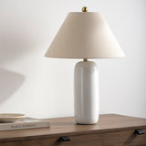 Featuring Vespa Table Lamp by Surya at Amethyst Home. A pretty matte white base with a creamy linen shade -- the Vespa lamp is sweet and subtle.  And the top little brass knob is precious!
Overall Dimensions: 26"H x 18"W x 18"D
Switch Type: On/OffNumber of bulbs: 1E-26/60 WUL CUL Certified.  Amethyst Home provides interior design, new home construction design consulting, vintage area rugs, and lighting in the Miami metro area.