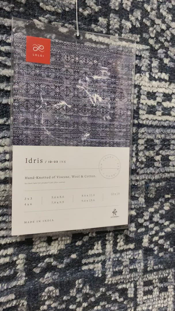 The Idris Ink area rug from Loloi is meticulously hand-knotted of viscose and wool. You will love this rug because the rug is:  Perfect for entryways, living rooms, and bedrooms Easy to clean and maintain Gorgeous with the intricate pattern and patina Warms up any room with the high / low pile Hand-Knotted 70% Viscose | 30% Wool ID-03 Ink