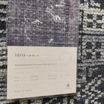 The Idris Ink area rug from Loloi is meticulously hand-knotted of viscose and wool. You will love this rug because the rug is:  Perfect for entryways, living rooms, and bedrooms Easy to clean and maintain Gorgeous with the intricate pattern and patina Warms up any room with the high / low pile Hand-Knotted 70% Viscose | 30% Wool ID-03 Ink
