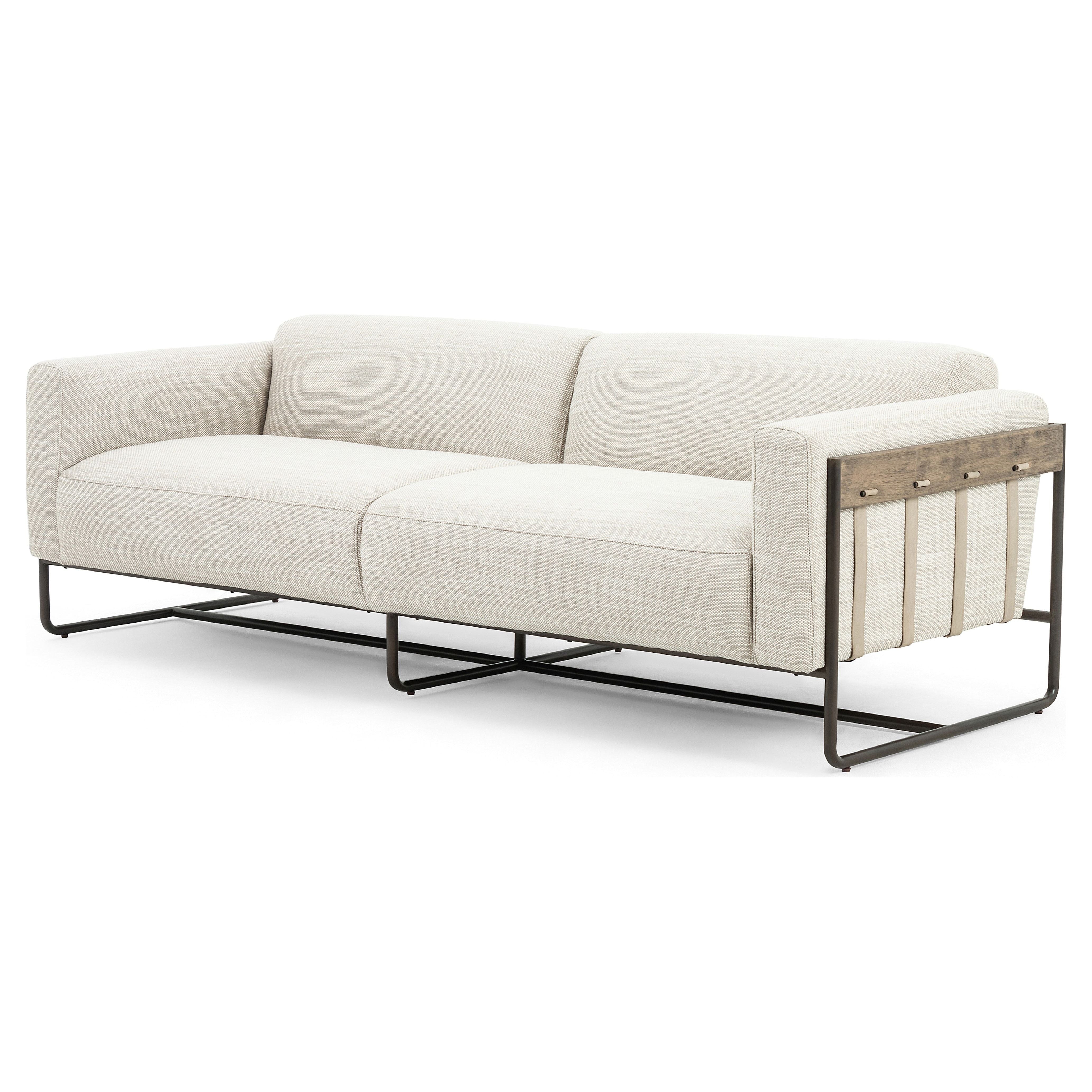 Neutral gone novel with this Ella Gable Taupe 91" Sofa. Taupe-colored upholstered seating is suspended by top-grain leather straps with handcrafted fastens, for an airy look. Solid rubberwood paneling wraps the frame’s entirety, while a black iron base lends lightness and contrast.  Available early October 2020!  Overall Dimensions: 91.00"w x 37.50"d x 30.25"h Materials: 82% Pl 16% Pc 2%Wo, Iron, 100% Top Grain Leath, Solid Parawood