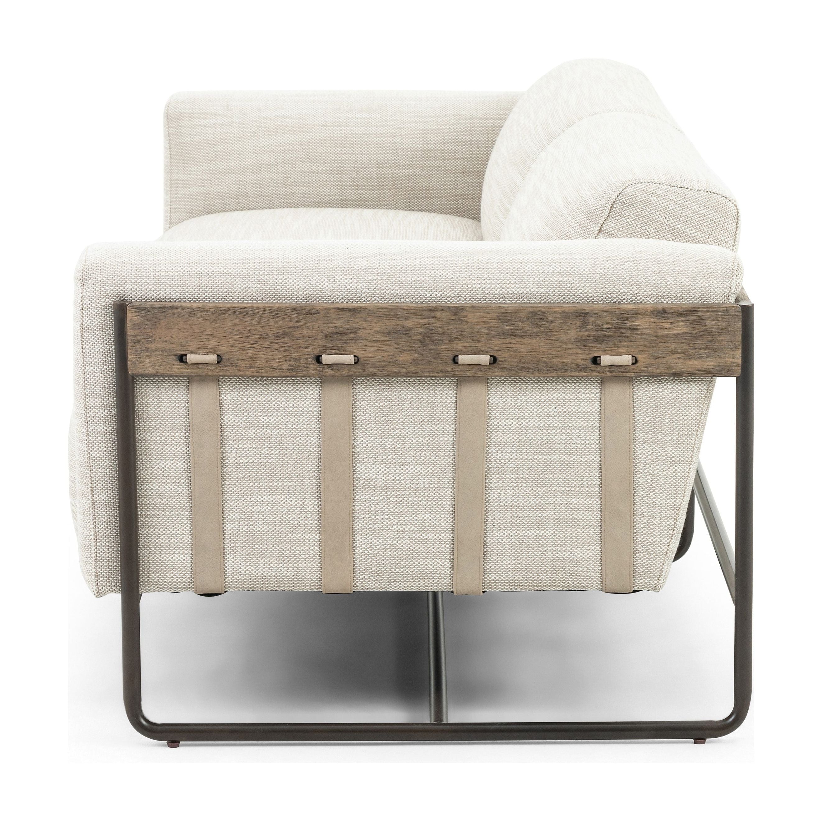 Neutral gone novel with this Ella Gable Taupe 91" Sofa. Taupe-colored upholstered seating is suspended by top-grain leather straps with handcrafted fastens, for an airy look. Solid rubberwood paneling wraps the frame’s entirety, while a black iron base lends lightness and contrast.  Available early October 2020!  Overall Dimensions: 91.00"w x 37.50"d x 30.25"h Materials: 82% Pl 16% Pc 2%Wo, Iron, 100% Top Grain Leath, Solid Parawood