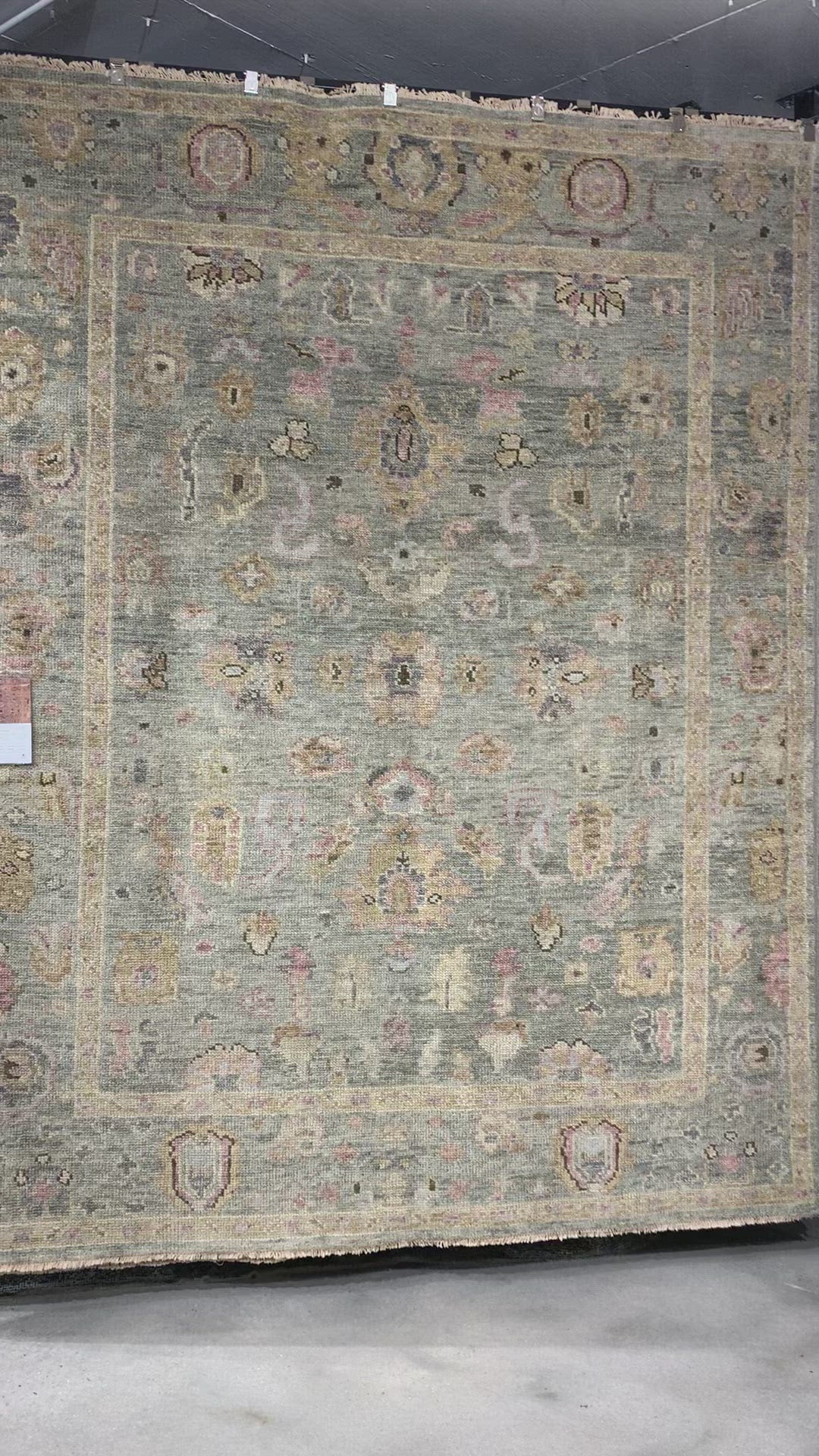 Load video: The Helena Sage / Sunset HEL-03 rug from Loloi is hand-knotted of 100% wool, refined, yet versatile for any home. The Helena rug combines weathered tones and worldly patterns for a beautiful grounding element in any room. Amethyst Home provides interior design, new construction, custom furniture, and rugs for the Omaha and Lincoln metro area.