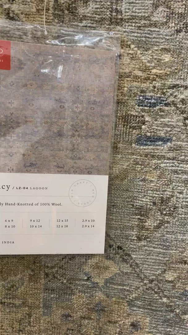Load video: The Legacy Lagoon rug from Loloi is hand-knotted, refined, yet versatile for any home. The Legacy rug is deliberately distressed and sheared down to an extra low pile of 100% wool, creating a patina usually only imparted through decades of wear.  This rug features: - Beautiful vintage look and patina - Extra low pile - Easy to clean and maintain - Perfect for living and dining rooms, hallways, and extra large spaces  Hand-Knotted 100% Wool LZ-04 Lagoon