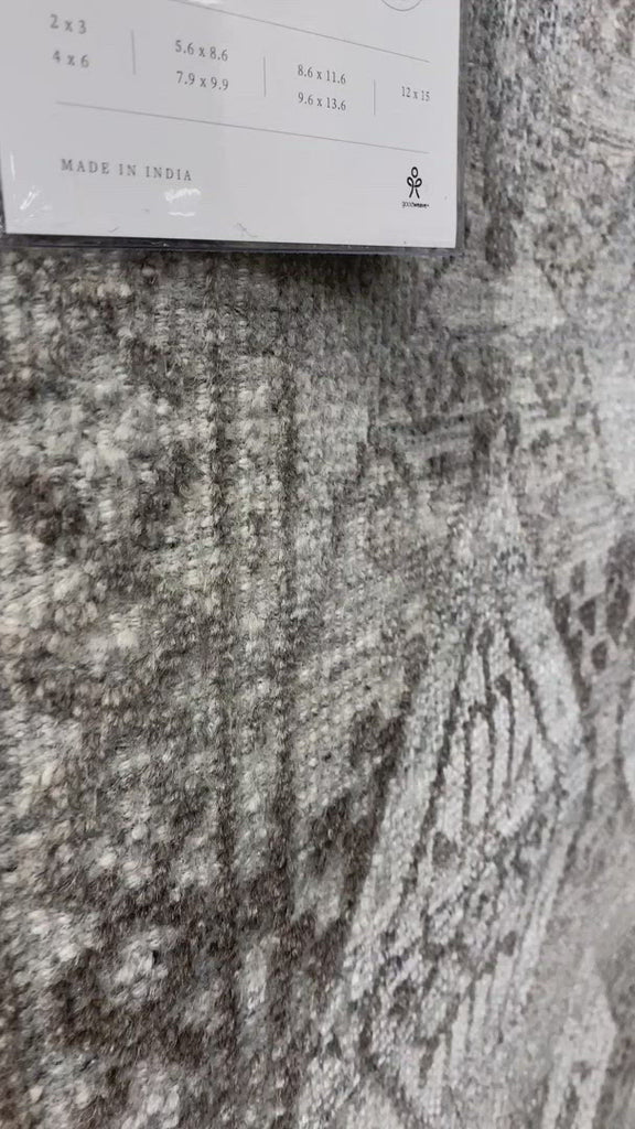 The Idris Stone area rug from Loloi is meticulously hand-knotted of viscose and wool. You will love this rug because the rug is:  Perfect for entryways, living rooms, and bedrooms Easy to clean and maintain Gorgeous with the intricate pattern and patina Warms up any room with the high / low pile Hand-Knotted 70% Viscose | 30% Wool ID-01 Stone
