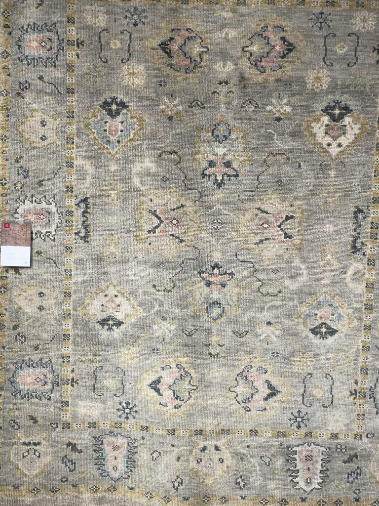 The Helena Grey / Gold HEL-04 rug from Loloi is hand-knotted of 100% wool, refined, yet versatile for any home. The Helena rug combines weathered tones and worldly patterns for a beautiful grounding element in any room. Amethyst Home provides interior design, new construction, custom furniture, and rugs for the Omaha and Lincoln metro area.