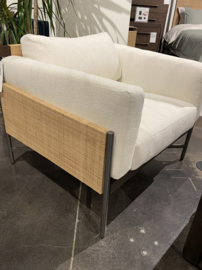 A float-like design brings a lightweight look to modern lounge seating with this Jordan Chair - Natural Cane. This piece features natural cane and warm brown mahogany pair with a charcoal-finished iron base for a fresh -- a refined look with organic presence for any living room, bedroom, or other area.   Overall Dimensions: 35.00"w x 31.00"d x 28.00"h