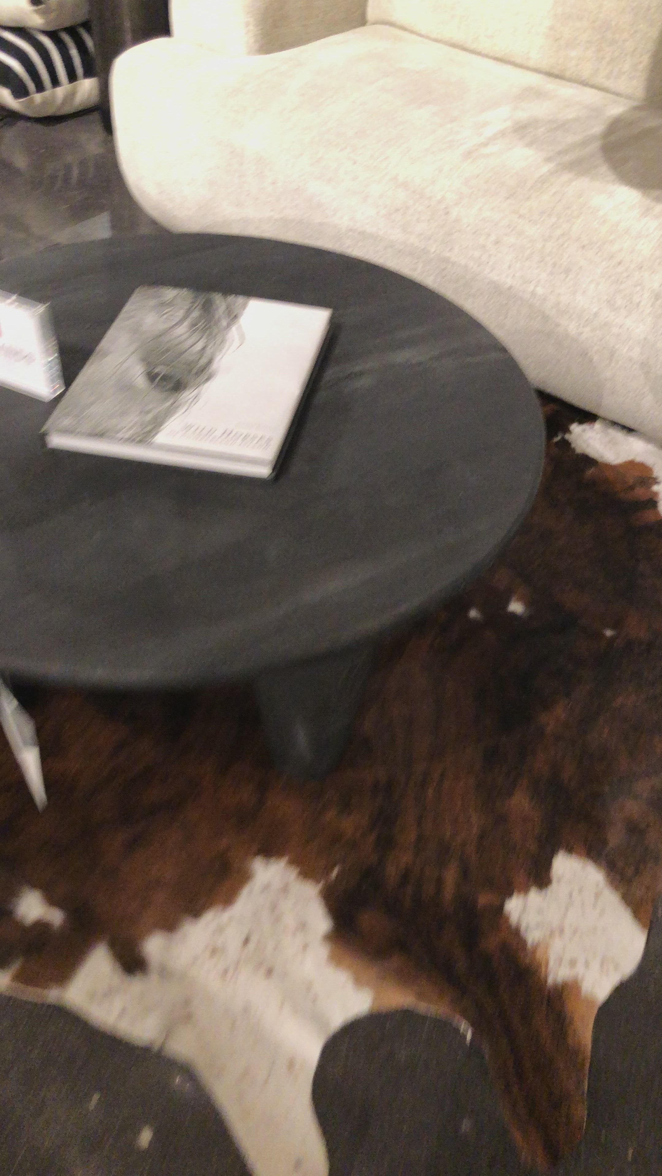 We love the shapely, substantial legs that support a slim, rounded tabletop of light black-finished reclaimed woods in this Maricopa Coffee Table - Dark Totem. A global, organic look with a handcrafted vibe.