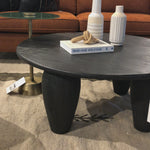 We love the shapely, substantial legs that support a slim, rounded tabletop of light black-finished reclaimed woods in this Maricopa Coffee Table - Dark Totem. A global, organic look with a handcrafted vibe.