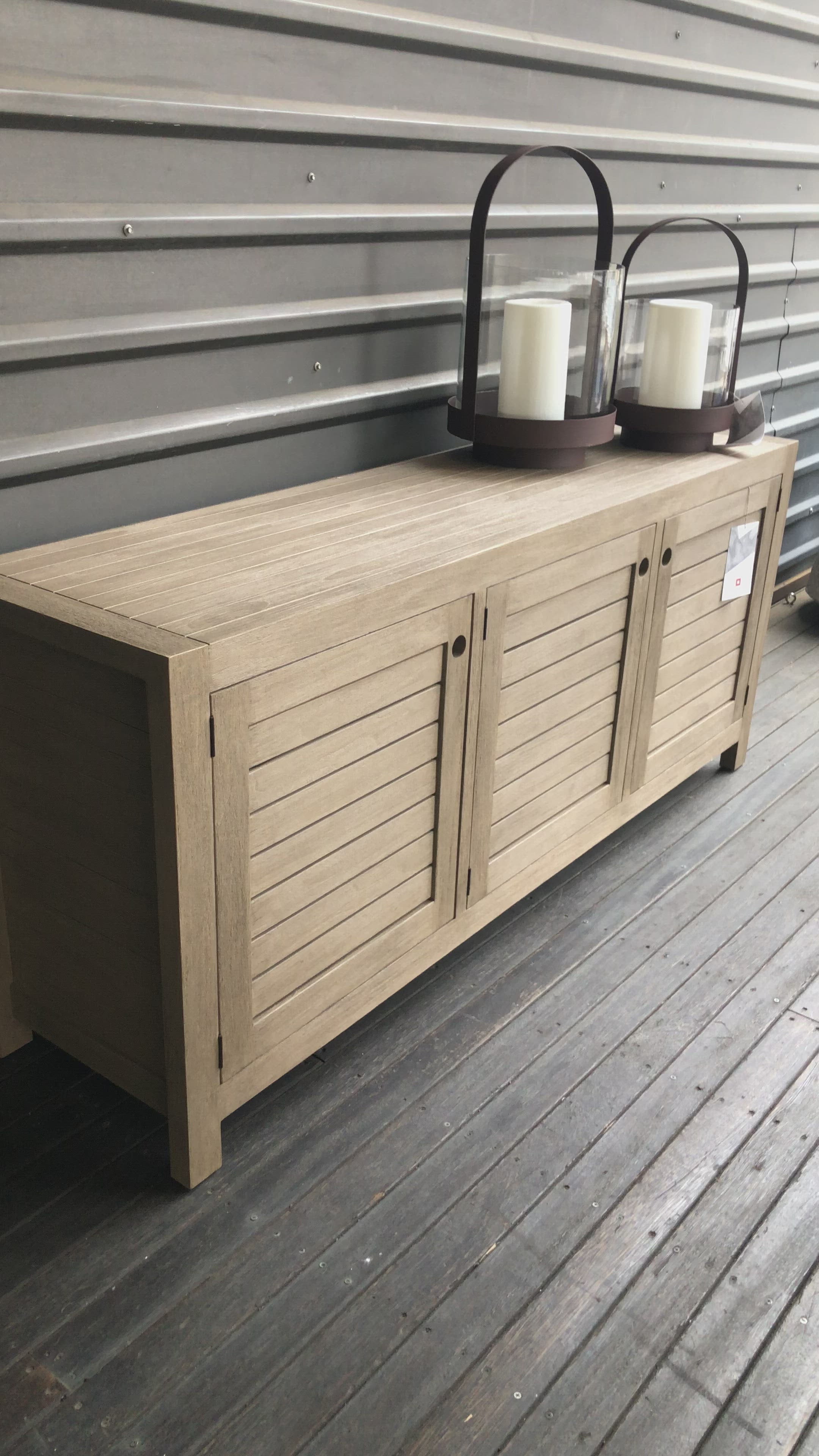 Load video: Take outdoor storage to the next level with this Sonoma Outdoor Sideboard - Weathered Grey. Finished in a weathered grey, solid FSC-certified teak forms a modern-minded sideboard, with slatted fronts for a light, linear look. Cover or store indoors during inclement weather and when not in use.  Overall Dimensions: 70.00&quot;w x 18.00&quot;d x 30.00&quot;h