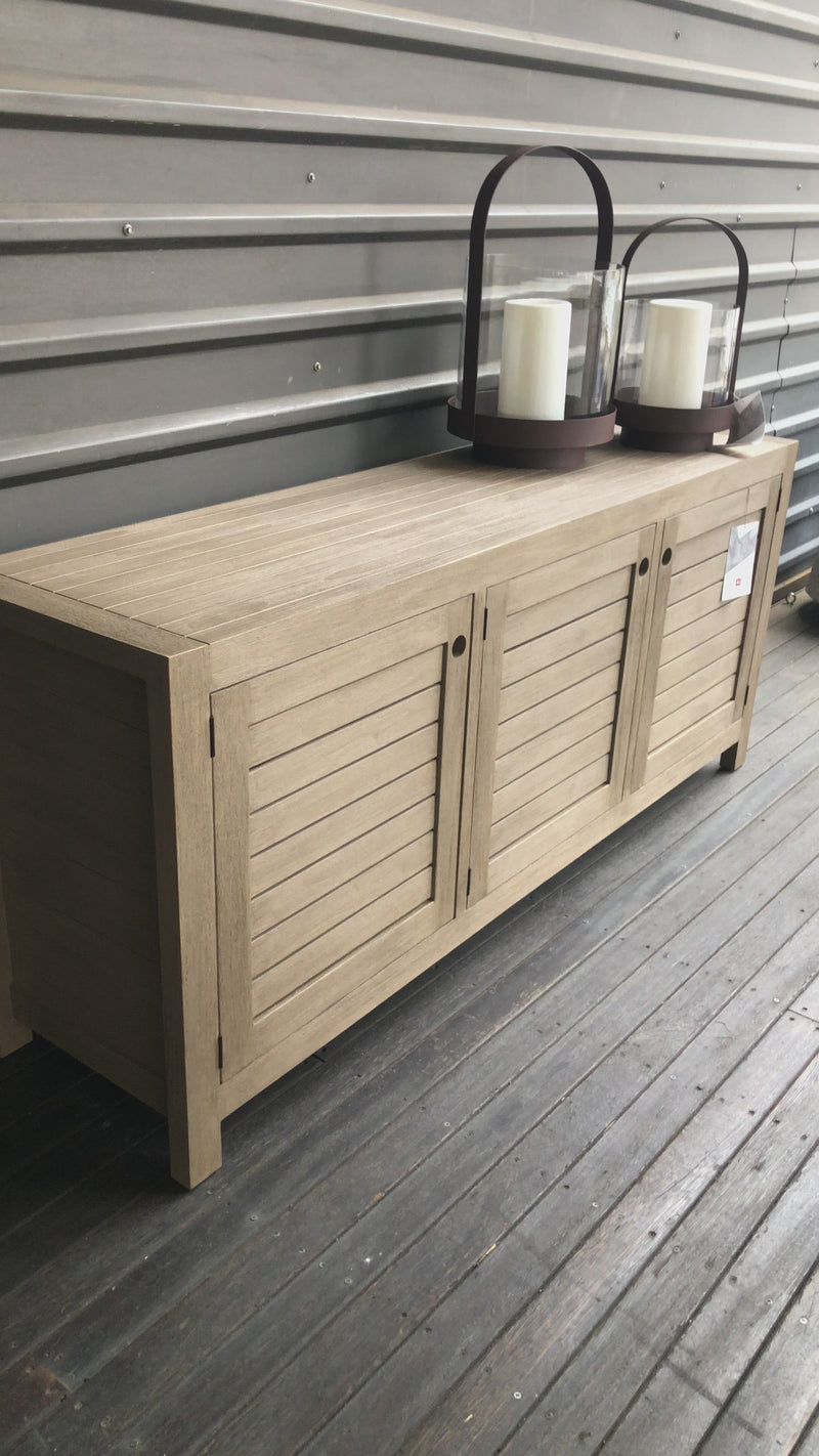 Take outdoor storage to the next level with this Sonoma Outdoor Sideboard - Weathered Grey. Finished in a weathered grey, solid FSC-certified teak forms a modern-minded sideboard, with slatted fronts for a light, linear look. Cover or store indoors during inclement weather and when not in use.  Overall Dimensions: 70.00"w x 18.00"d x 30.00"h
