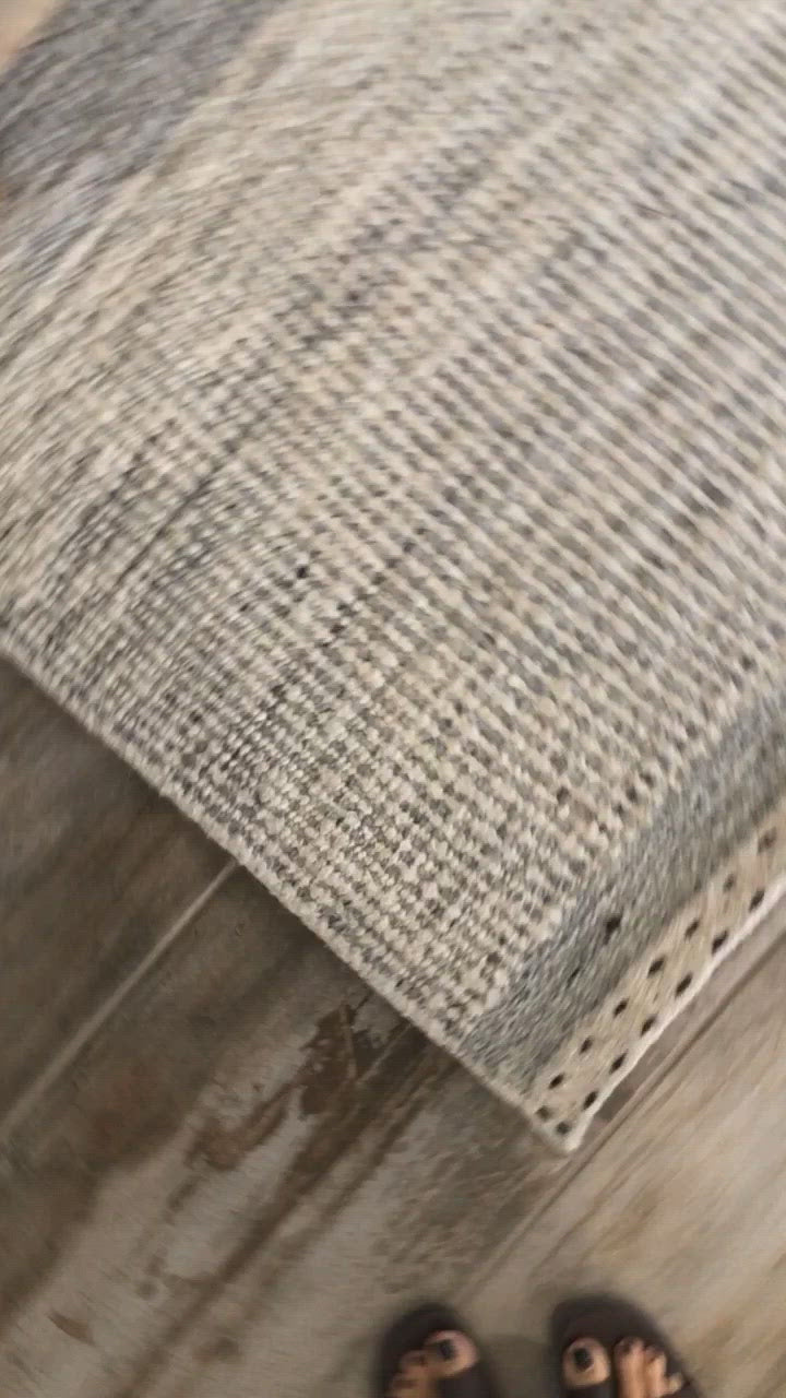 Load video: A perfect blend of refined and relaxed, the Sloane Collection is hand-woven of wool, cotton and polyester by artisans in India. Sloane offers a sophisticated foundation for a contemporarily bohemian look with perfectly woven stripes and minimalist appeal.  Hand Woven 79% Wool | 10% Cotton | 8% Polyester | 3% Other Fibers SLN-01 Mist