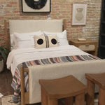 Bring a cozy hygge vibe to the bedroom with this textured Bowen Bed. Framed by light-finished solid oak, a sling-style bed features faux shearling head and foot boards -- sure to elevate any bedroom.   Queen Overall Dimensions: 64.25"w x 87.25"d x 48.00"h King Overall Dimensions: 80.25"w x 88.50"d x 48.00"h