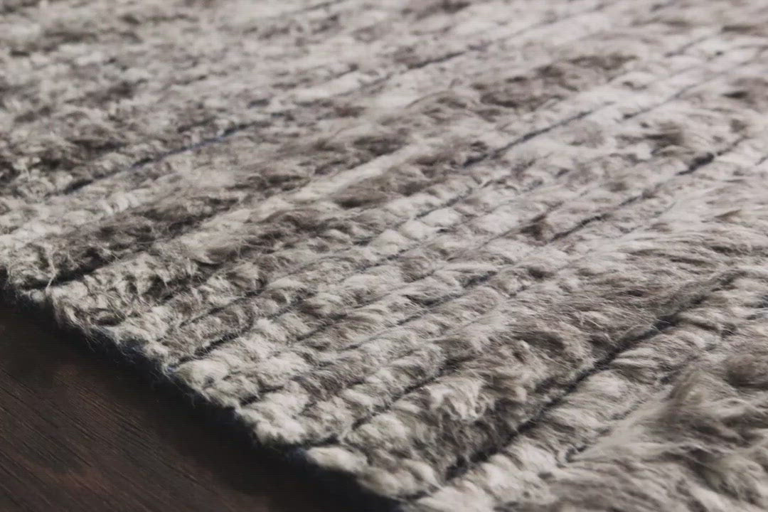 A nod to timeless Moroccan style, the Khalid Pewter/Ink Area rug is hand-knotted in India by skilled artisans. The soft pile features 100% natural, undyed wool, lending slight variations in tones that make each piece it's own. Plus, each rug is finished with a thoughtfully designed fringe.  Hand-Knotted 100% Wool KF-04 Pewter/Ink