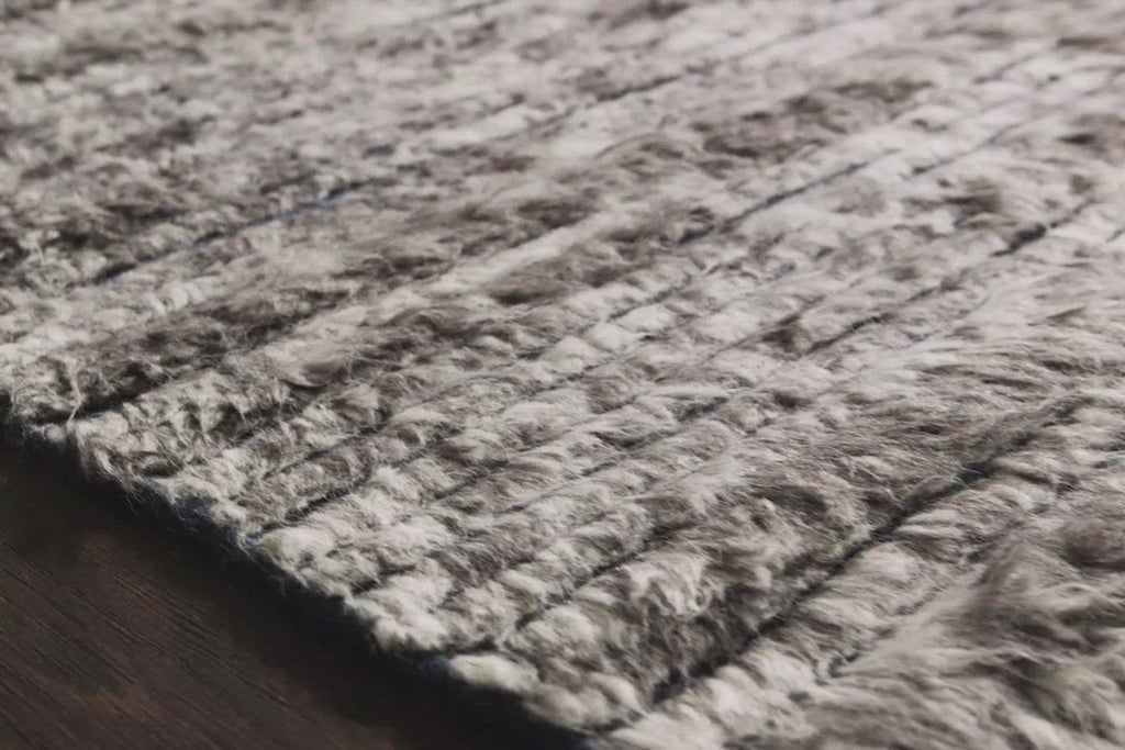 A nod to timeless Moroccan style, the Khalid Pewter/Ink Area rug is hand-knotted in India by skilled artisans. The soft pile features 100% natural, undyed wool, lending slight variations in tones that make each piece it's own. Plus, each rug is finished with a thoughtfully designed fringe.  Hand-Knotted 100% Wool KF-04 Pewter/Ink