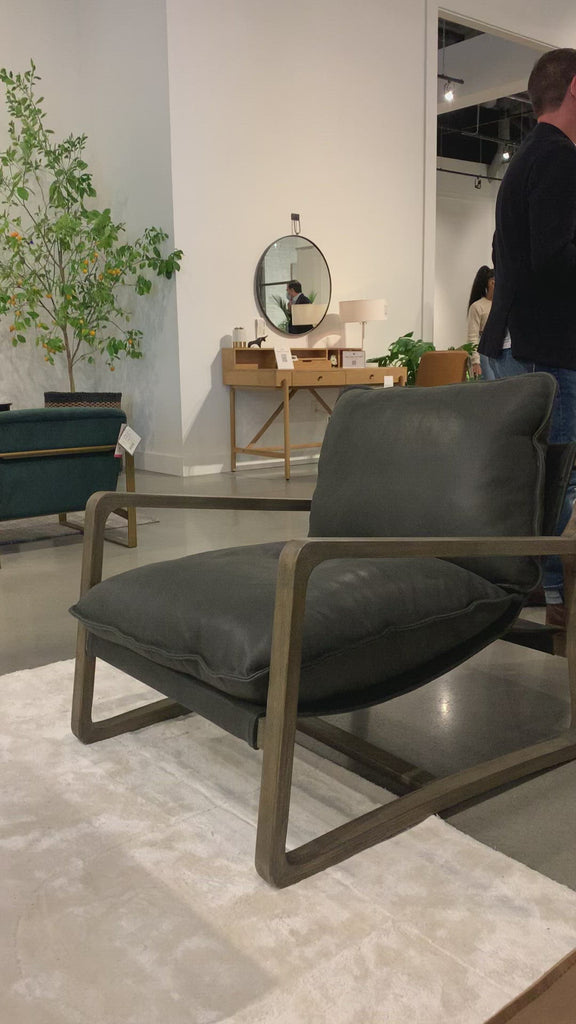 This Ace Chair - Umber Black is the perfect place to relax or curl up with a good book. Hand-shaped oak frame supports deep, low seating covered in black top-grain leather for a comfortable seat in any living room or office.   Overall Dimensions: 30.00"w x 37.00"d x 31.00"h