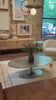 We love the oval shape of this Simone Coffee Table - Antique Nickel. The textural cast aluminum makes for a beautifully modern coffee table, with alluring highs and lows played up by a raw nickel finish. Great indoors or out; cover or store indoors during inclement weather and when not in use.  Overall Dimensions: 54.75"w x 29.25"d x 16.50"h