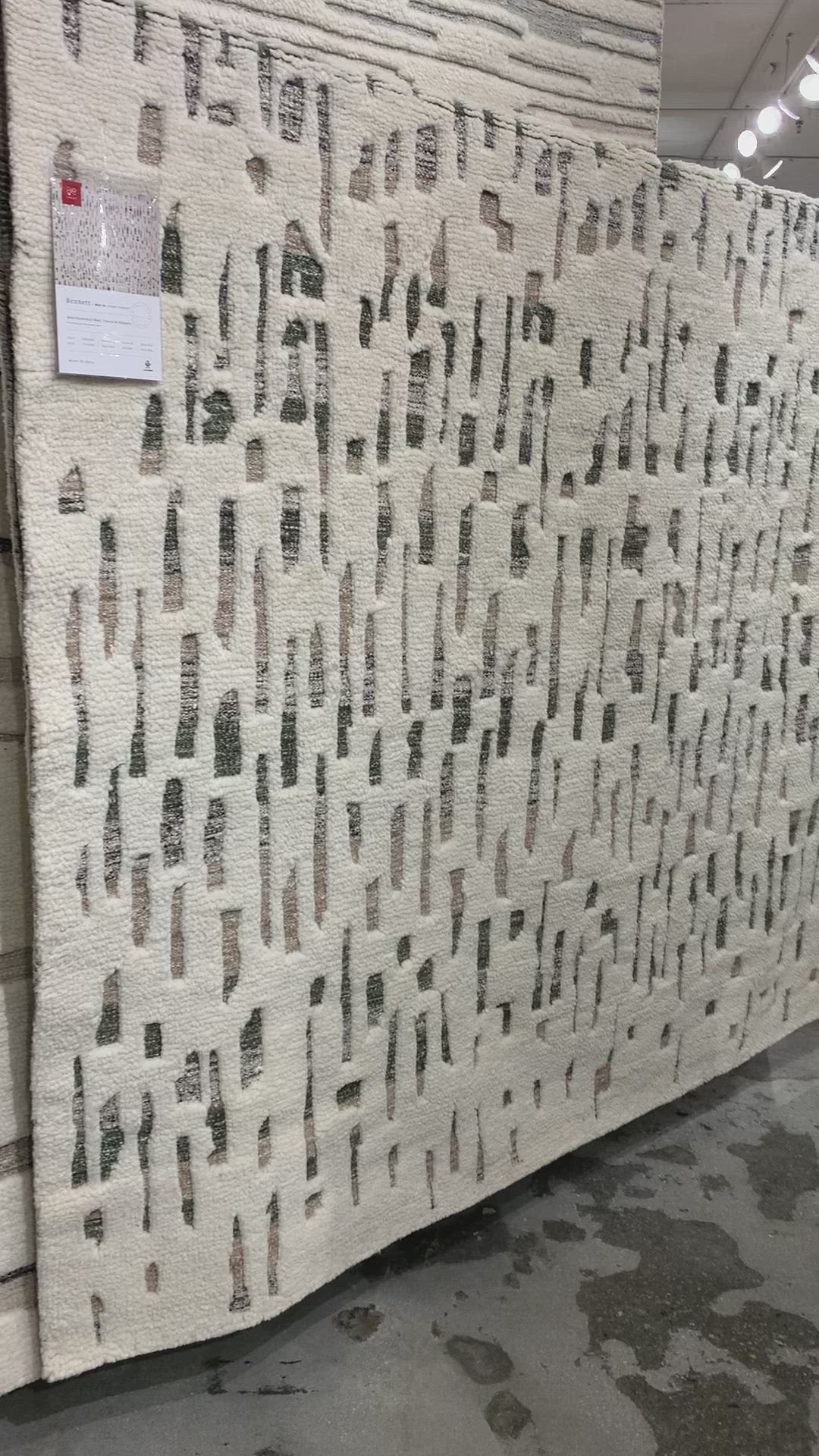 Load video: The Loloi Bennett Ivory / Forest Area Rug, or BEN-06, is hand-knotted of wool, viscose and polyester in India. Featuring a new carve like high-low pile, Bennett has an ivory base with abstract tonal designs. Plus, it&#39;s plush underfoot-- a great choice for your office, bedroom, or other medium traffic areas. 