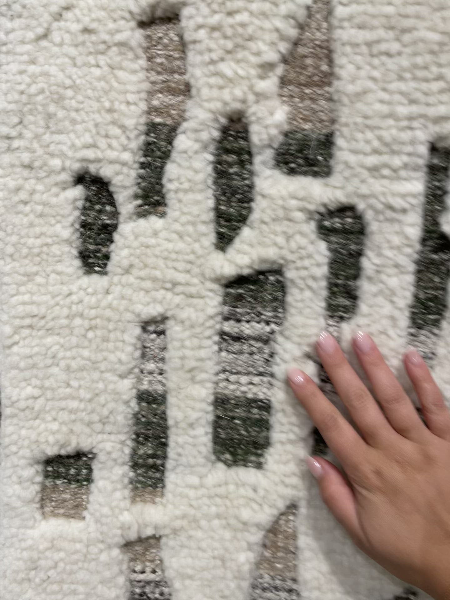 Load video: The Loloi Bennett Ivory / Forest Area Rug, or BEN-06, is hand-knotted of wool, viscose and polyester in India. Featuring a new carve like high-low pile, Bennett has an ivory base with abstract tonal designs. Plus, it&#39;s plush underfoot-- a great choice for your office, bedroom, or other medium traffic areas. 