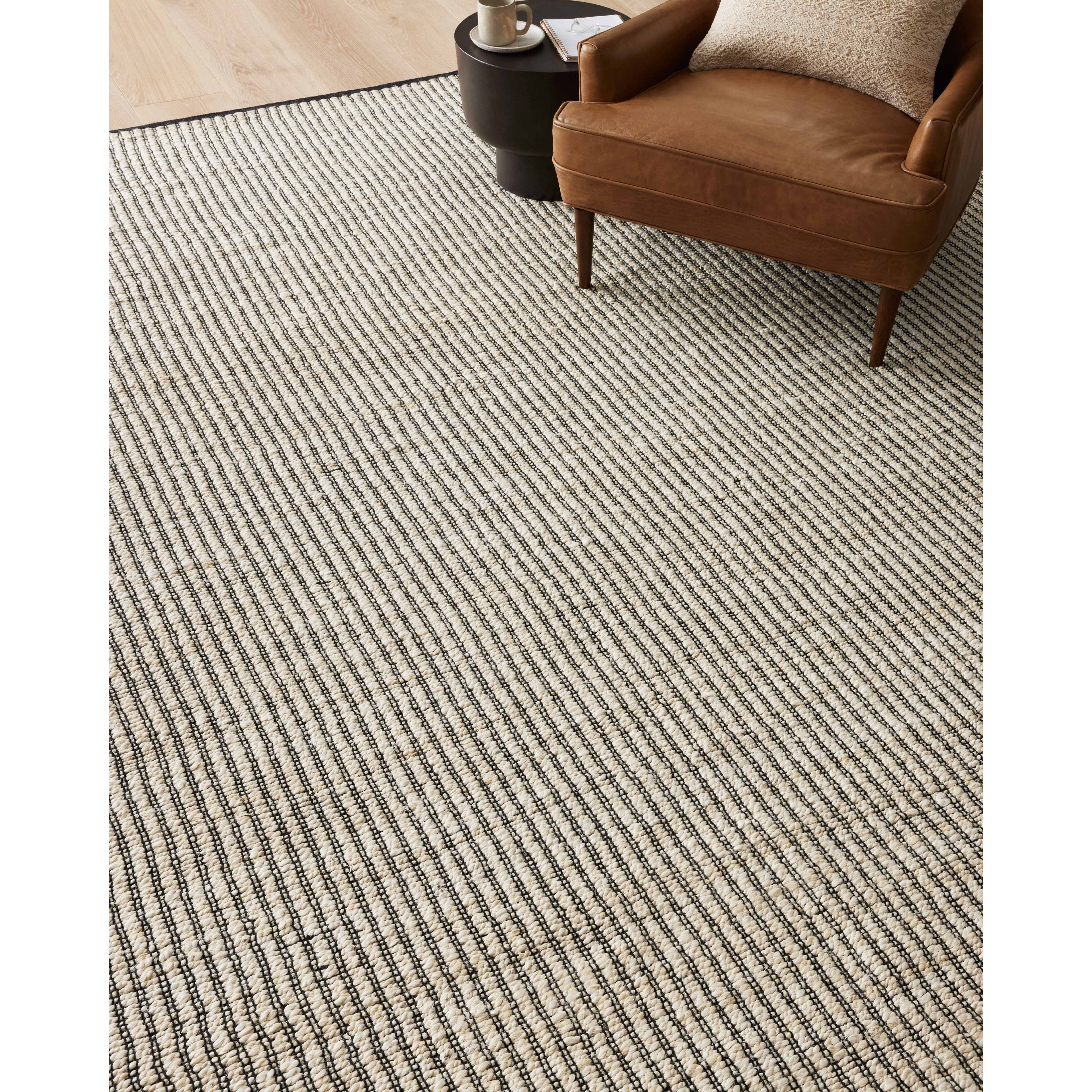 Featuring Angela Rose x Loloi Colton Ivory / Black Rug by Loloi at Amethyst Home. The Angela Rose x Loloi Colton Ivory / Black rug is a new take on the staple jute rug, blended with cotton for added softness. In a range of linear designs in modern earth tones, Colton can add visual interest to a room or serve as a gently textured neutral. This collection is hand-woven in India and GoodWea. Amethyst Home provides interior design services, furniture, rugs, and lighting in the Winter Park metro area.